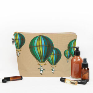 Muted Blue Penguin in Flight Toiletry Bag